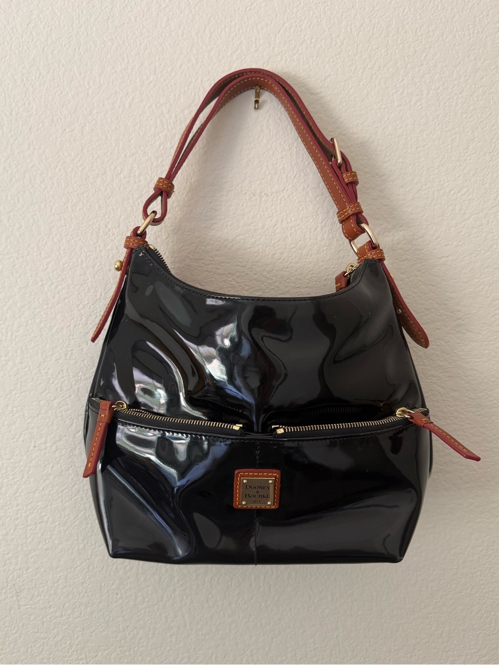 Dooney & Bourke Black Patent Leather Hobo Bag with Tan Trim